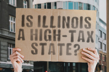 The question " Is Illinois a high-tax state? " is on a banner in men's hands with blurred background. Cost. Budget. Crisis. Decision. Earnings. Freedom. Interest. Revenue