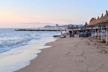 Obraz premium Sunset at Beach in Albania Golem Beach by sunset with sand and water and Durrës in the Background.