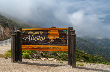 Skagway, Alaska, USA - July 20, 2011: Klondike highway to Canada. Colorful Welcome sign near the...