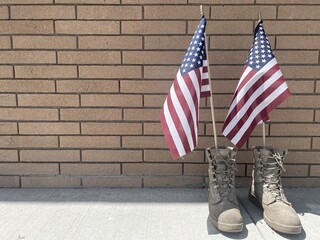 Memorial Day or Veterans day concept. Old military combat boots with the American flag. Worn...
