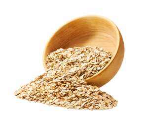 Grains oatmeal flakes are scattered out of the wooden bowl.