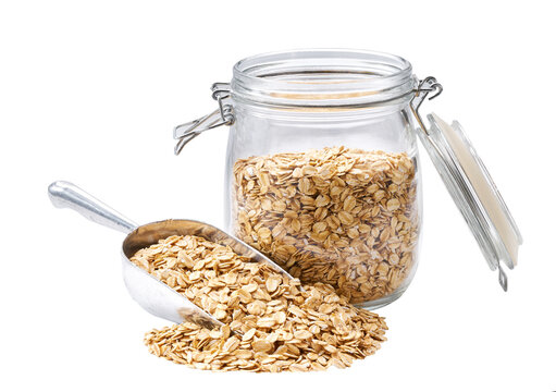 oatmeal flakes in metal scoop and  in glass storage jar isolated on white background.