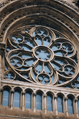 Old openwork round window with stained glass on facade of the building. Baroque and Gothic architecture. Church of St. Olga and Elizabeth. Lviv, Ukraine.
