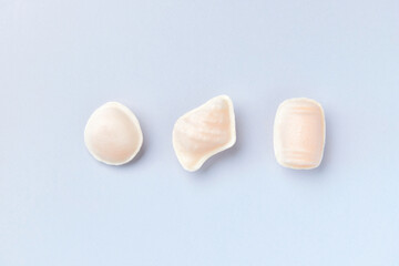 Flat lay top view of traditional portuguese egg yolk sweets Ovos Moles de Aveiro on blue background. Gastronomy tourism.