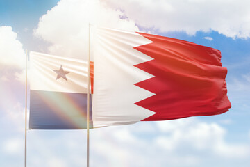 Sunny blue sky and flags of bahrain and panama