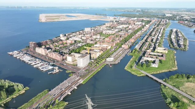 Amsterdam Ijburg artificial island modern residential area smart city cityscape at water Ijmeer. Urban houses buildings city environment area.