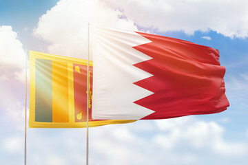 Sunny blue sky and flags of bahrain and sri lanka