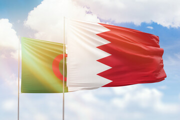 Sunny blue sky and flags of bahrain and algeria