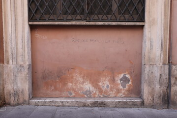 Aged Pink Facade Detail with Graffiti in Rome, Italy