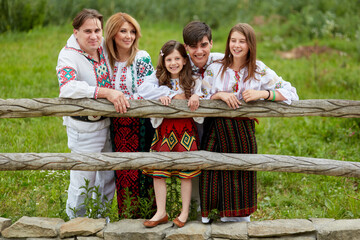 Beautiful family with kids in traditional clothes. Father, mother, son and daughters posing...