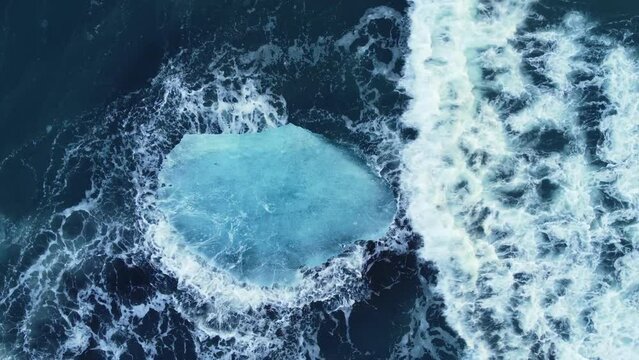 Iceberg in the ocean, Huge Chunks of Blue Ice floating on the waves, Arctic landscape aerial view, clean water, global warming and climate change concept