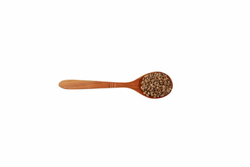 Hemp seeds or cannabis seeds in brown wooden spoon on white background, top view. Cannabis seeds are source of Omega-3 fatty acids, protein, magnesium and other trace elements