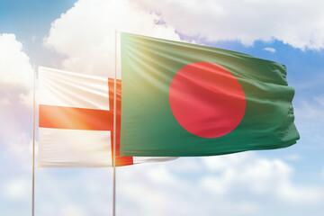 Sunny blue sky and flags of bangladesh and england