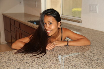 Obraz na płótnie Canvas Woman posing on new kitchen tiles