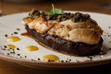 Baked eggplant stuffed with grilled chicken, tomatoes and spices on white plate. Traditional dish Karniyarik of turkish cuisine. View from above