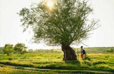 Man by old willow tree © adrianad