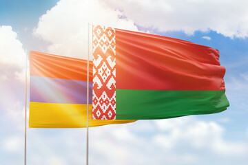 Sunny blue sky and flags of belarus and armenia