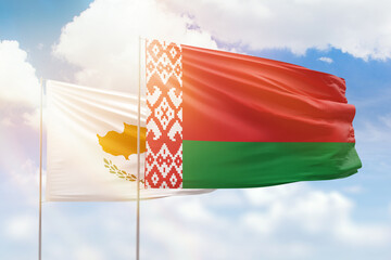 Sunny blue sky and flags of belarus and cyprus
