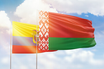 Sunny blue sky and flags of belarus and ecuador