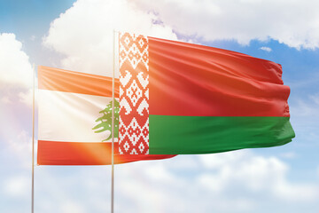 Sunny blue sky and flags of belarus and lebanon