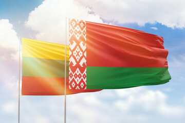 Sunny blue sky and flags of belarus and lithuania