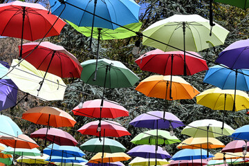 Colorful shade umbrellas over an outdoor dining area.