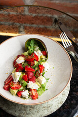 Tasty and healthy salad with arugula, brie cheese, avocado, cherry tomatoes and strawberry. Top view. The flat lay. Banner