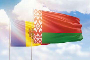 Sunny blue sky and flags of belarus and moldova