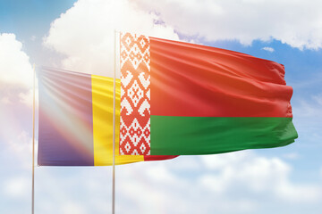 Sunny blue sky and flags of belarus and romania