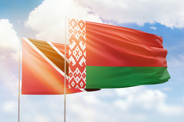 Sunny blue sky and flags of belarus and trinidad and tobago