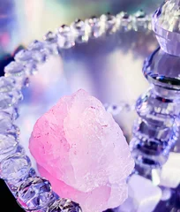 Foto op Aluminium pure rose quartz displayed on a decorative mirrored glass staand © glimmersDarkly