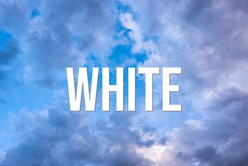 Fototapeta premium WHITE - word on the background of the sky with clouds.