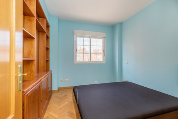 Fototapeta na wymiar bedroom with double bed, wooden furniture with shelves and white aluminum window with views