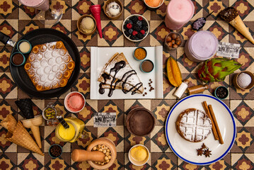 Set of sweet desserts, brownie, fruit and chocolate flavored ice cream, berries, nuts, pancakes