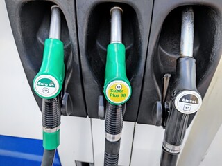 gas pump nozzles (hoses) at gas station in the Netherlands. Gasoline prices are still very high due...