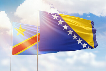 Sunny blue sky and flags of bosnia and dr congo