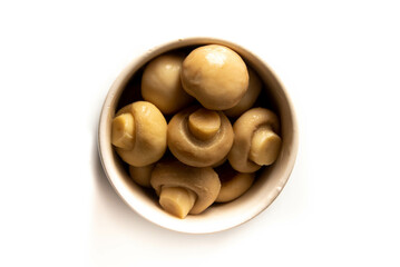 pickled mushrooms in white pot top view isolated on white background.