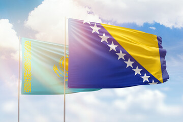 Sunny blue sky and flags of bosnia and kazakhstan