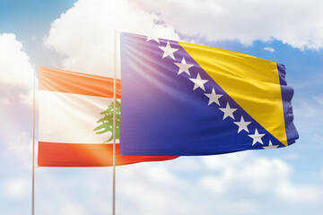 Sunny blue sky and flags of bosnia and lebanon