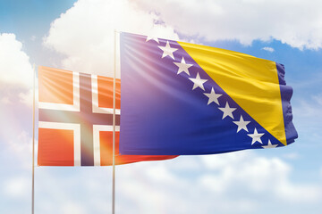 Sunny blue sky and flags of bosnia and norway