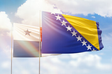 Sunny blue sky and flags of bosnia and panama