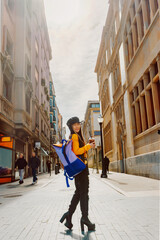 Asian young woman with backpack sightseeing in a European city while having a special coffee.