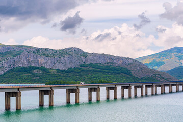 Camper circulating through the viaduct of the Riaño reservoir, Leon, Spain.