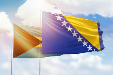 Sunny blue sky and flags of bosnia and bahamas