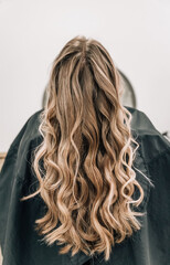 Close-up of a bun of shiny blonde hair curls