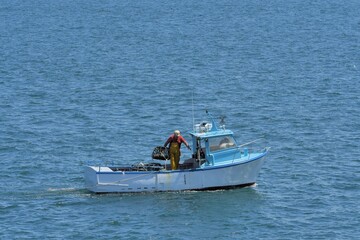 Fototapeta na wymiar Fisherman on his boat fishing crustaceans in Brittany France