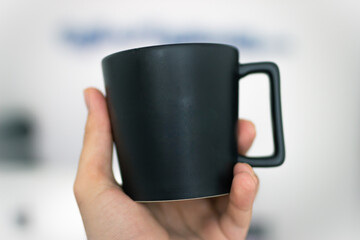 hand holding a cup mug 2