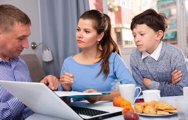 Focused young woman with preteen son meeting financial adviser for investment at home..