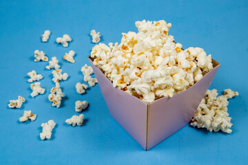 A paper bowl of salted popcorn