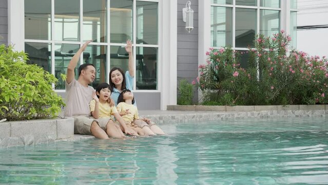 Happiness family relaxation at poolside in the home with enjoyment together, summer holiday, father and mother and children leisure at swimming pool with happy, relationship and bonding.